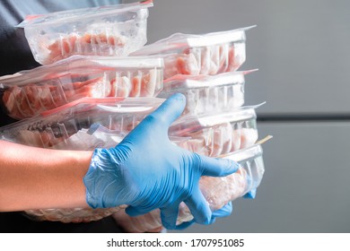 Housewife Wearing Blue Latex Gloves Stocking Fresh Pork In Refrigerator Freezer. People Panic And Prepare To Pandemic Quarantine.  Stay At Home Policy From Government During Coronavirus Or COVID-19