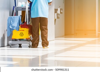 Housewives With Mop Bucket Car And Equipment Janitorial For Cleaning The Floor Inside The Building. To Maintain Customer Cleanliness And Health.