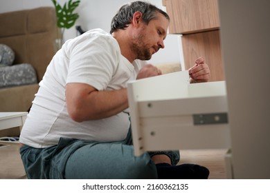 Housework, Father Fixing A Broken Shelf. Distribution Of Duties