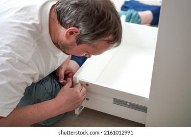 Housework, Father Fixing A Broken Shelf. Distribution Of Duties