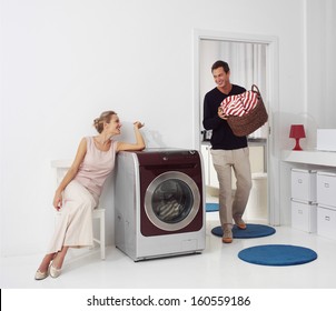 Housework, Young Woman And Man Doing Laundry