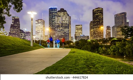 Houston City Skyline As Night Falls And People Enjoying Eleanor Tinsley Park