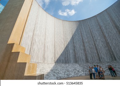 HOUSTON, TEXAS - AUGUST 14; Tourists Pose For Photo In Diagonal Shadow In Front Hines Water Wall Feature On Ausust 14, 2016, Houston, Texas, USA