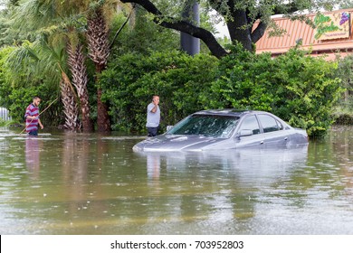 Houston, Texas - August 27, 2017: Houston Residents Walk Across The Flooded Street In Houston, Texas, USA. Heavy Rains From Hurricane Harvey Caused Many Flooded Areas In Houston.