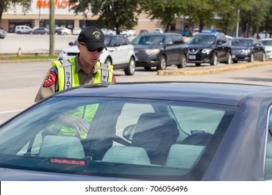 Houston, Texas, August 30, 2017: A Texas Department Of Public Safety State Trooper Talks With A Car Driver As He Coordinates A Donation Drive Near NRG Center