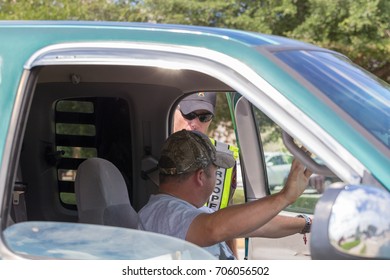 Houston, Texas, August 30, 2017: A Texas Department Of Public Safety State Trooper Talks With A Truck Driver As He Coordinates A Donation Drive Near NRG Center