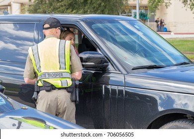 Houston, Texas, August 30, 2017: A Texas Department Of Public Safety State Trooper Talks With A SUV Passenger As He Coordinates A Donation Drive Near NRG Center