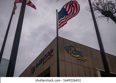 Houston, Texas - February 11, 2020: American Flag Under Storm Clouds Near Joel Osteen's Lakewood Mega Church