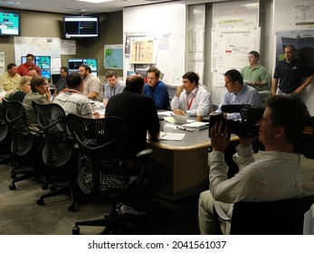 Houston, Texas - July 16, 2010: British Petroleum Scientists And Engineers At Office Table Discuss How To Stop The Deeepwater Horizon Oil Spill While Being Filmed By The National Geographic Channel