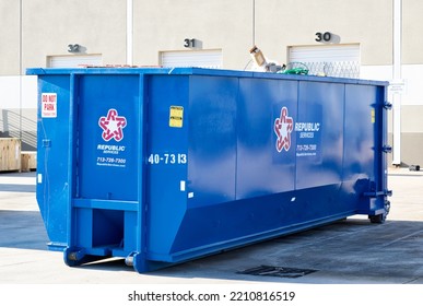 Houston, Texas USA 09-18-2022: Republic Services Waste Management Solid Trash Dumpster Bin In A Warehouse Yard.