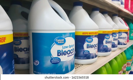 Houston, Texas USA 12-23-2019: Generic bleach bottles on a supermarket shelf in a Walmart Supercenter. Great Value brand, rows of containers. Hygienic cleaning supplies.
