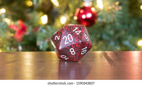 Houston, Texas / USA - December 16, 2019: Red D20 Dice By Christmas Tree For D&D And TTRPG