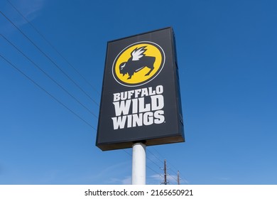 Houston, Texas, USA - March, 2, 2022: A Buffalo Wild Wings Pole Sign With Blue Sky In Background. Buffalo Wild Wings Is An American Casual Dining Restaurant And Sports Bar Franchise. 