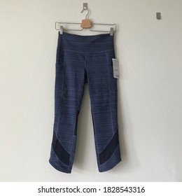 Houston, Texas / USA - September 22, 2020: Athleta Leggings, Blue, On Clothes Hanger On Wall