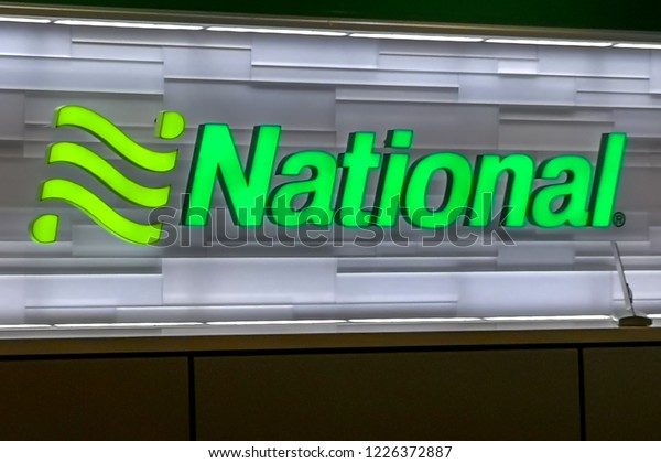 Houston, Texas, USA - September 22,\
2018: Sign of National Car Rental at Airport Counter ,  an American\
rental car agency owned by Enterprise Holdings.\
