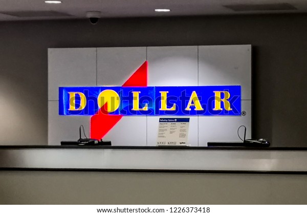 Houston, Texas, USA\
- September 22, 2018: Sign of Dollar Rent A Car at Airport Counter\
,  an American rental car agency Operating as a subsidiary of The\
Hertz Corporation. 