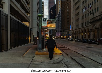 Houston, TX USA - January 5th, 2022: Man Walking To Train Stop Downtown At Night.