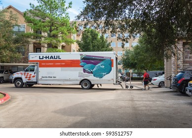 HOUSTON, TX, US-OCT 1, 2016: Side View Of U-Haul Truck Parked, Open Door, Loading Ramp And Mover Carries Goods. It Is An American Moving Equipment And Storage Rental Company, Based In Phoenix, Arizona