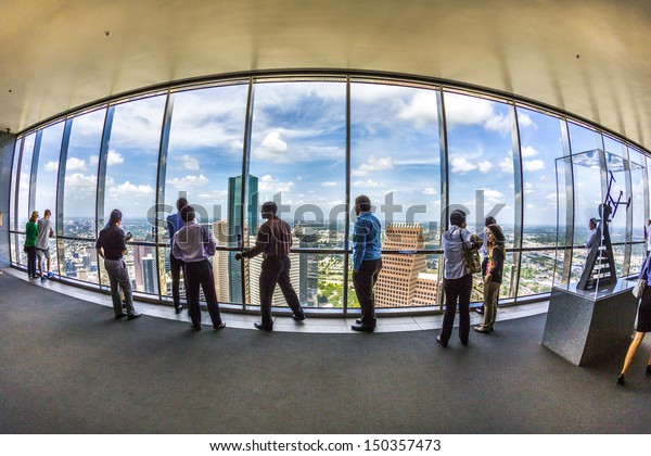 HOUSTON, USA - JULY 11: people enjoy the scenic view\
from JPMorgan Chase tower on July 11, 2013 in Houston, USA. The\
visitor platform is open to public during office hours without\
entrance fee.