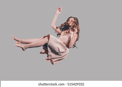 Hovering in air. Studio shot of attractive young woman hovering in air