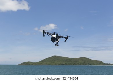 hovering drone with camera in clear blue sky