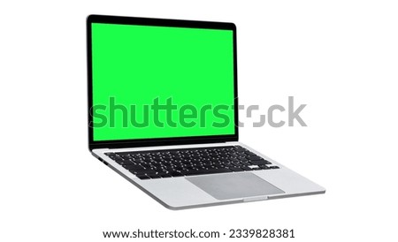 Hovering  laptop with green screen and new design, isolated on a white background.