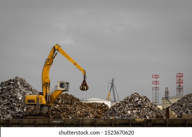 How all metal things will end. Scrapyard with big yellow machine to move metal parts around. - Powered by Shutterstock