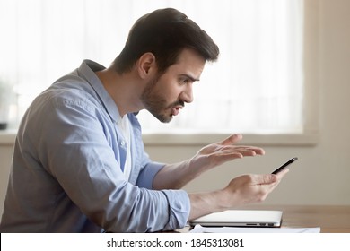 But how... Angry mad shocked millennial male brawling by mobile phone with client support of bank online shop store scolding bad service poor quality of goods purchased slow incorrect application work