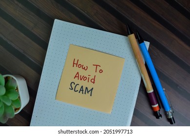 How To Avoid Scam Write On Sticky Notes Isolated On Wooden Table.