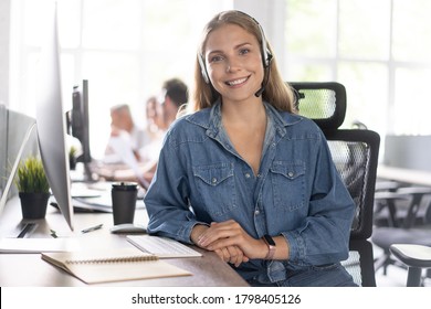 How Can I Help You? Beautiful Call Center Workers In Headphones Are Working At Modern Office