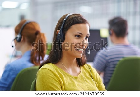 How can I help you. Shot of an attractive female at work wearing headsets.