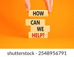 How can we help symbol. Concept words How can we help on beautiful wooden blocks. Beautiful orange table orange background. Businessman hand. Business and how can we help concept. Copy space.