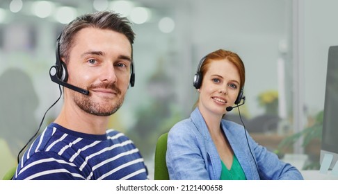 How can we make a difference. Portrait of two business colleagues wearing headsets in the office.