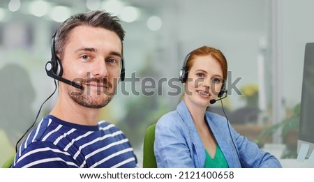 How can we make a difference. Portrait of two business colleagues wearing headsets in the office.