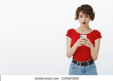 How Could You Post This Picture. Shocked Insulted Concerned Young Girlfriend Found Photo Ex Girlfriend Boyfriend Smartphone Drop Jaw Gasping Surprised Stare Cellphone Speechless White Background