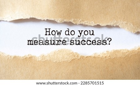 How do you measure success?. Words written under torn paper.