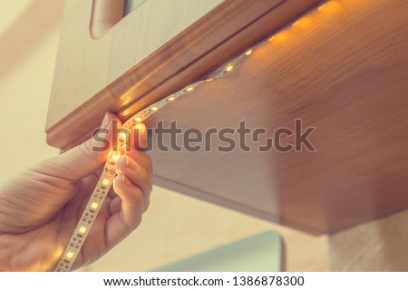 How to install led strip for lighting correctly on the surface of the Cabinet on the kitchen set