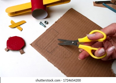 How to make airplane. Hand made toy,zero waste from toilet paper roll and popsicle sticks. For kids and parents. Step 12 draw details for tail. DIY for child, ideas to make during home quarantine. - Powered by Shutterstock