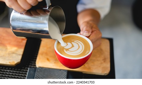 how to make coffee latte art by barista focus in milk and coffee cup in cafe shop - Powered by Shutterstock