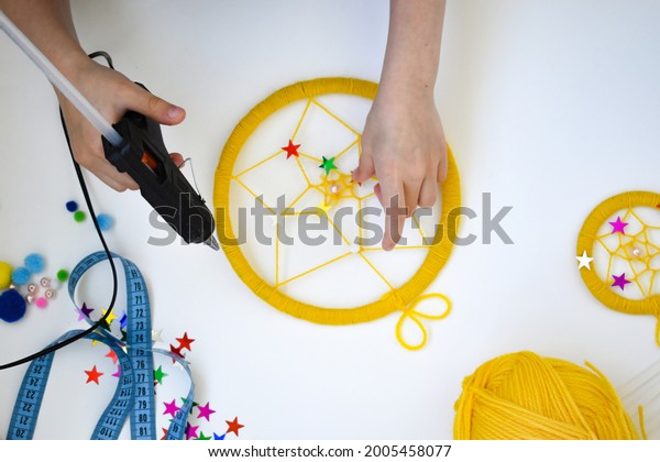How to make a
dream catcher at home. Hands make a dream catcher out of thread.
Instruction. Step 7. Decorate the catcher with beads, pompoms and
stars. 10 July 2021 Russia