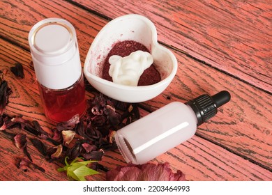 How To Make Face Mask Based On Hibiscus Step By Step, DIY Natural Cosmetics Concept, Face Mask From Hibiscus Cream And Powder In Bowl, Spray Lotion And Serum With Hibiscus Extract On Wooden Background