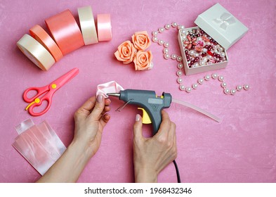 How To Make A Rose From A Ribbon, Fabric With Your Own Hands.DIY Crafts.Satin Ribbons, Stones,rhinestones,scissors.Step 3.Step By Step Instructions.In The Hands Of A Glue Gun,the Girl Glues  A Hairpin