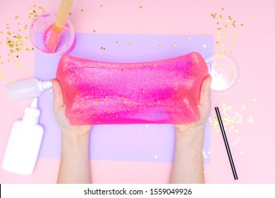 How To Make Slime At Home. Children Art Project. DIY Concept. Kids Hands Making Slime Toy On Pink. Step By Step Photo Instruction. Step 12