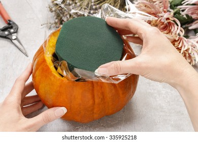 How To Make A Thanksgiving Centerpiece - Step By Step: Cut The Floral Foam And Put Into The Pumpkin.