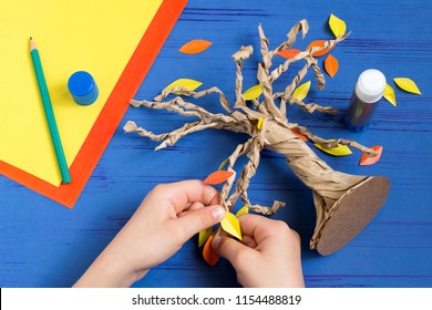 How to make together with child autumn tree from craft package. Original children's art project. DIY concept. Step-by-step photo instructions. Step 9. Glue leaves of tree