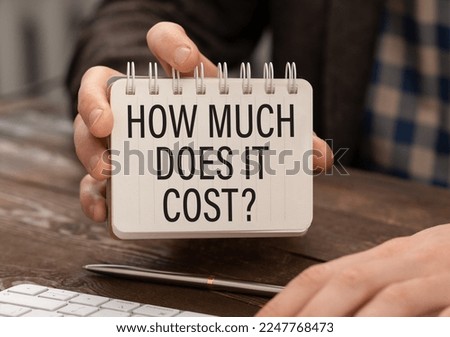 How much does it cost text written in the notebook in hand.