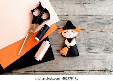 How To Sew A Halloween Witch Decor. Step. Halloween Felt Witch With Broom, Beige And Black Thread, Needle, Scissors, Felt Set On Old Wooden Background. Easy Halloween Doll Crafts For Kids. Top View 