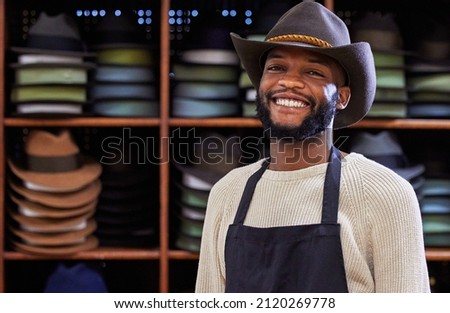 Howdy. Shot of a young man working at his job in a shop.