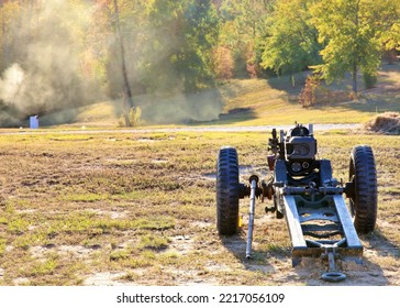 Howitzer Cannon Overlooking A Smoky Field