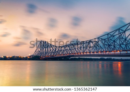 Howrah bridge - The historic cantilever bridge on the river Hooghly in West Bengal with twilight sky. Howrah bridge is considered as the busiest bridge in India. 